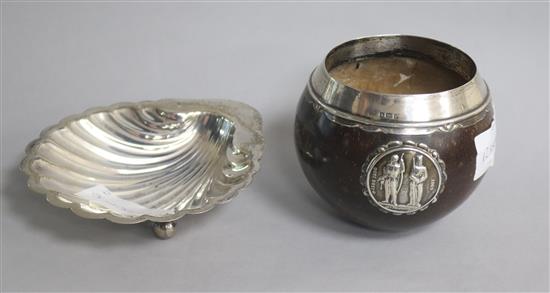 A George V silver mounted coconut shell with National Rifle Association appliqué and a silver butter shell.